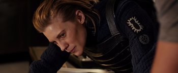 Movie still from “Riddick” (2013), directed by David Twohy – A man with long hair is leaning against a wall; Close Up shot, Low angle