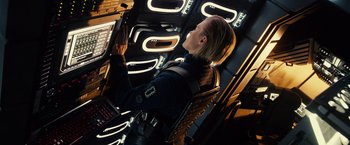 Movie still from “Riddick” (2013), directed by David Twohy – A woman in a space suit is looking up; Medium shot, Overhead angle