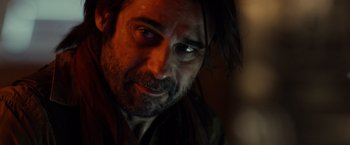 Movie still from “Riddick” (2013), directed by David Twohy – A person with a beard looking at the camera; Close Up shot, Over the shoulder angle