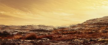 Movie still from “Riddick” (2013), directed by David Twohy – A desert landscape with mountains in the background; Extreme Wide shot, High angle