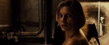 Movie still from “Riddick” (2013), directed by David Twohy – A young woman with blonde hair and a bare chest; Close Up shot, Low angle