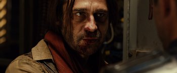 Movie still from “Riddick” (2013), directed by David Twohy – A person with a beard; Close Up shot, Low angle