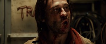 Movie still from “Riddick” (2013), directed by David Twohy – A person with blood on his face; Close Up shot, Low angle