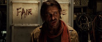 Movie still from “Riddick” (2013), directed by David Twohy – A person wearing a scarf; Close Up shot, Over the shoulder angle