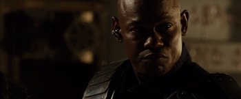 Movie still from “Riddick” (2013), directed by David Twohy – A person wearing a headset; Close Up shot, Over the shoulder angle