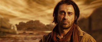 Movie still from “Riddick” (2013), directed by David Twohy – A person with long hair; Close Up shot, Over the shoulder angle