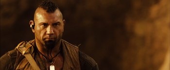 Movie still from “Riddick” (2013), directed by David Twohy – A person with a beard; Close Up shot, Low angle