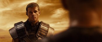 Movie still from “Riddick” (2013), directed by David Twohy – A person wearing a suit of armor; Close Up shot, Over the shoulder angle