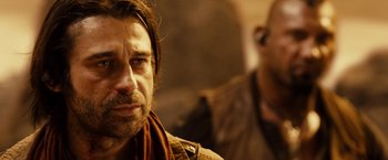 Movie still from “Riddick” (2013), directed by David Twohy – A person with a beard; Close Up shot, Over the shoulder angle