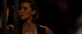 Movie still from “Riddick” (2013), directed by David Twohy – A person wearing a leather vest; Close Up shot, Over the shoulder angle