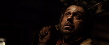 Movie still from “Riddick” (2013), directed by David Twohy – A person holding a knife in his hand; Close Up shot, High angle