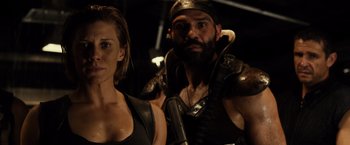 Movie still from “Riddick” (2013), directed by David Twohy – A man and a woman are posing for a picture; Close Up shot, Over the shoulder angle