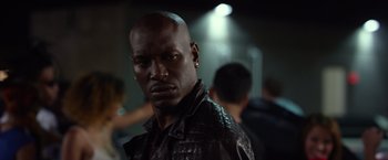 Movie still from “Ride Along 2” (2016), directed by Tim Story – A person wearing a leather jacket; Close Up shot, Over the shoulder angle