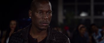 Movie still from “Ride Along 2” (2016), directed by Tim Story – A person wearing a leather jacket; Close Up shot, Over the shoulder angle