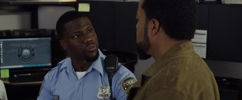 Movie still from “Ride Along 2” (2016), directed by Tim Story – A police officer talking to a man in uniform; Close Up shot, Over the shoulder angle