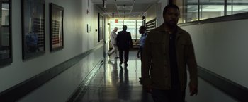 Movie still from “Ride Along 2” (2016), directed by Tim Story – A group of people walking down a hallway; Wide shot, Over the shoulder angle