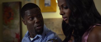 Movie still from “Ride Along 2” (2016), directed by Tim Story – A man and a woman in police uniforms; Close Up shot, Over the shoulder angle