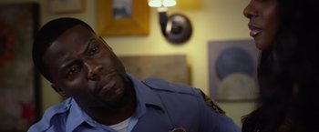Movie still from “Ride Along 2” (2016), directed by Tim Story – A police officer sitting in front of a mirror; Close Up shot, Over the shoulder angle