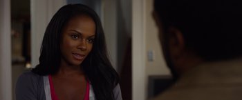 Movie still from “Ride Along 2” (2016), directed by Tim Story – A beautiful young woman with long black hair; Close Up shot, Over the shoulder angle