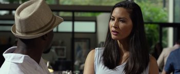 Movie still from “Ride Along 2” (2016), directed by Tim Story – A beautiful woman with long black hair looking at the camera; Close Up shot, Over the shoulder angle