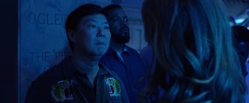 Movie still from “Ride Along 2” (2016), directed by Tim Story – A group of men and a woman standing next to each other in a dark room; Close Up shot, Over the shoulder angle