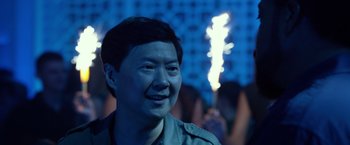 Movie still from “Ride Along 2” (2016), directed by Tim Story – A man smiles while standing in front of a crowd; Close Up shot, Over the shoulder angle