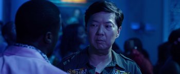 Movie still from “Ride Along 2” (2016), directed by Tim Story – A person wearing a shirt with a tiger on it; Close Up shot, Over the shoulder angle