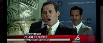 Movie still from “Ride Along 2” (2016), directed by Tim Story – A man in a suit and tie is talking to the press; Close Up shot, Low angle