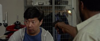 Movie still from “Ride Along 2” (2016), directed by Tim Story – A person holding a gun pointed at a man; Close Up shot, Over the shoulder angle