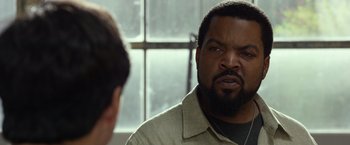 Movie still from “Ride Along 2” (2016), directed by Tim Story – A man with a goatee looking at a mirror; Close Up shot, Over the shoulder angle