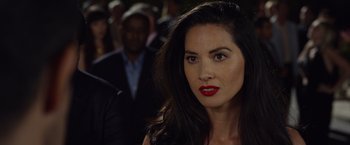 Movie still from “Ride Along 2” (2016), directed by Tim Story – A woman with red lipstick is standing in front of a group of people; Close Up shot, Over the shoulder angle