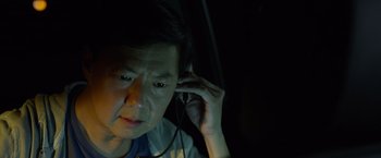 Movie still from “Ride Along 2” (2016), directed by Tim Story – An asian man with headphones in a dark room; Close Up shot, High angle