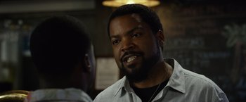 Movie still from “Ride Along 2” (2016), directed by Tim Story – A man with a goatee talking to another man in front of him; Close Up shot, Over the shoulder angle