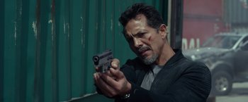 Movie still from “Ride Along 2” (2016), directed by Tim Story – A man holding a gun in his hand; Close Up shot, Over the shoulder angle