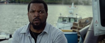Movie still from “Ride Along 2” (2016), directed by Tim Story – A man with a serious look on his face; Close Up shot, Over the shoulder angle