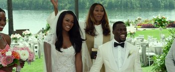 Movie still from “Ride Along 2” (2016), directed by Tim Story – A group of people standing next to each other on a dock; Medium shot, Over the shoulder angle