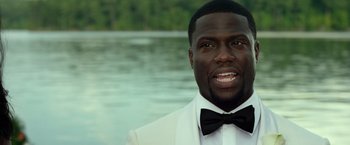 Movie still from “Ride Along 2” (2016), directed by Tim Story – A person wearing a suit and a bow tie; Close Up shot, Over the shoulder angle