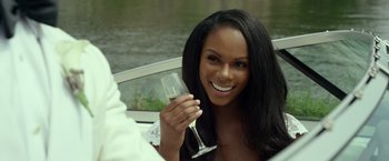 Movie still from “Ride Along 2” (2016), directed by Tim Story – A woman holding a glass of wine while sitting in a boat; Close Up shot, Over the shoulder angle