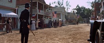 Movie still from “Ride the High Country” (1962), directed by Sam Peckinpah – A group of people standing in front of a building; Extreme Wide shot, Low angle