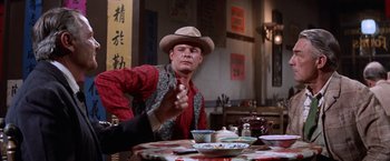 Movie still from “Ride the High Country” (1962), directed by Sam Peckinpah – A man sitting at a table with a bowl of soup; Medium shot, Over the shoulder angle