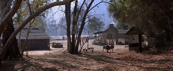 Movie still from “Ride the High Country” (1962), directed by Sam Peckinpah – An old fashioned farm with a tree and a barn; Extreme Wide shot, High angle