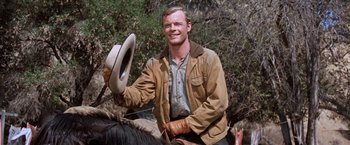 Movie still from “Ride the High Country” (1962), directed by Sam Peckinpah – A man on a horse holding a hat in his hand; Medium shot, Low angle