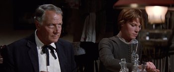Movie still from “Ride the High Country” (1962), directed by Sam Peckinpah – A man and a woman sitting next to each other in a room; Close Up shot, Over the shoulder angle