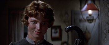 Movie still from “Ride the High Country” (1962), directed by Sam Peckinpah – A woman with short brown hair is smiling at the camera; Close Up shot, Low angle