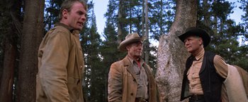 Movie still from “Ride the High Country” (1962), directed by Sam Peckinpah – A man in a cowboy hat standing next to another man; Medium shot, Low angle