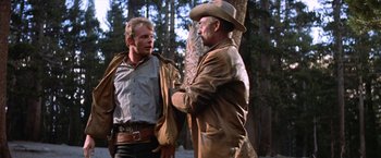 Movie still from “Ride the High Country” (1962), directed by Sam Peckinpah – Two men in cowboy hats talking to each other; Medium shot, Low angle