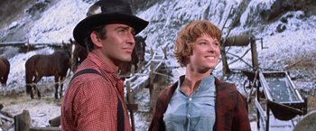 Movie still from “Ride the High Country” (1962), directed by Sam Peckinpah – A man and a woman standing next to each other; Medium shot, Low angle