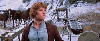 Movie still from “Ride the High Country” (1962), directed by Sam Peckinpah – A woman standing in front of a snowy mountain; Close Up shot, Low angle