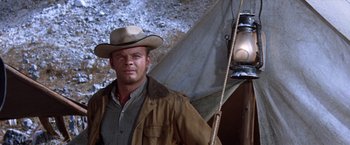 Movie still from “Ride the High Country” (1962), directed by Sam Peckinpah – A man with a hat and a light in a tent; Close Up shot, Low angle