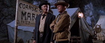 Movie still from “Ride the High Country” (1962), directed by Sam Peckinpah – A couple of men standing next to each other; Medium shot, Low angle